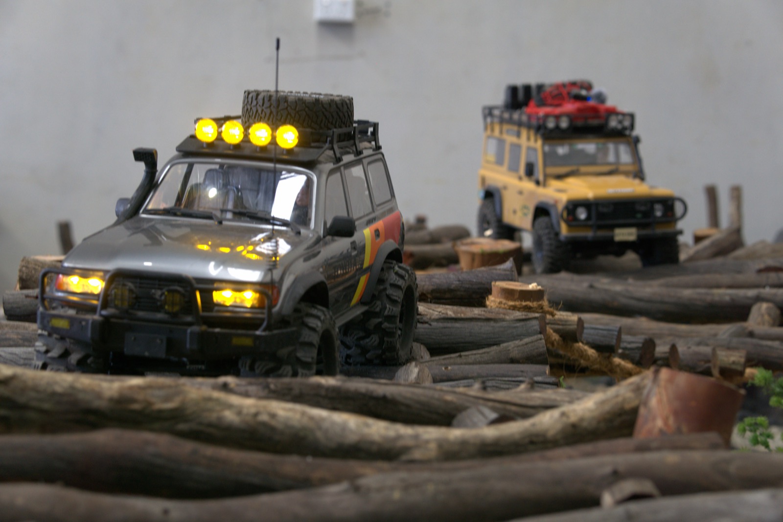 Radio-controlled 4WD crawler climbing rocks on the indoor off-road course in Epping